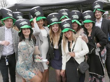 A large group of race goers in St Patricks Day hats