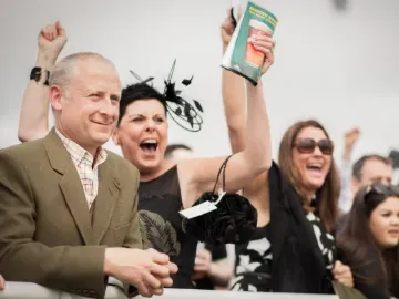 The crowd at Newcastle Racecourse cheer for a win