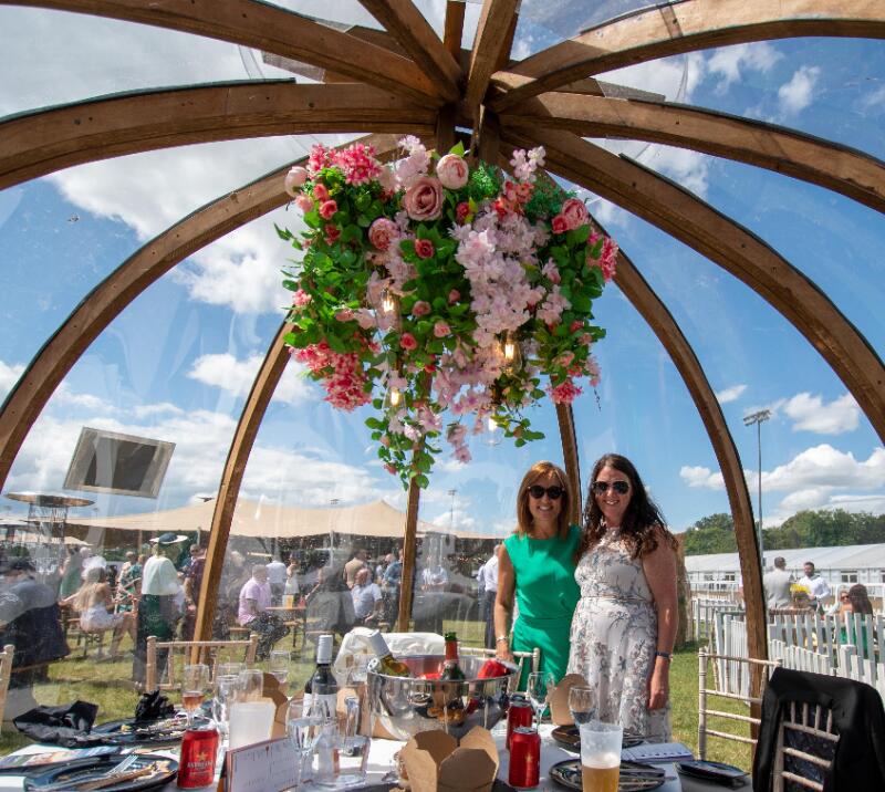Two hospitality guests at Newcastle Racecourse enjoying their pod.
